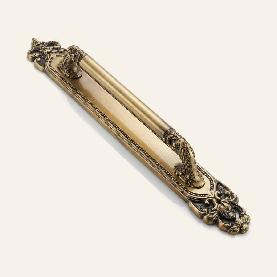 Athena solid brass pull handle with scrolled grip on beaded backplate