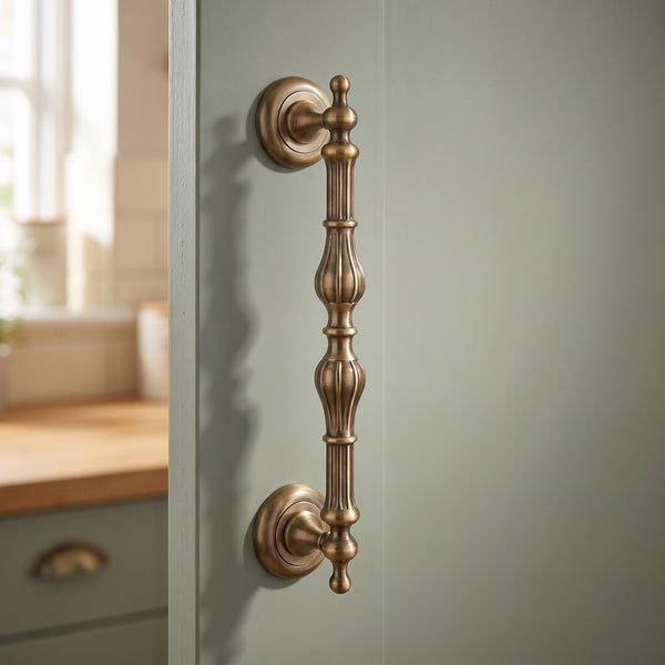 Castor Solid Brass Cabinet Pull in Antique, 12-inch, fitted on a kitchen pantry door
