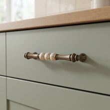 Bellora Curved Dome Bar Handle in Antique Brass+Brown, 160mm, fitted on a kitchen drawer