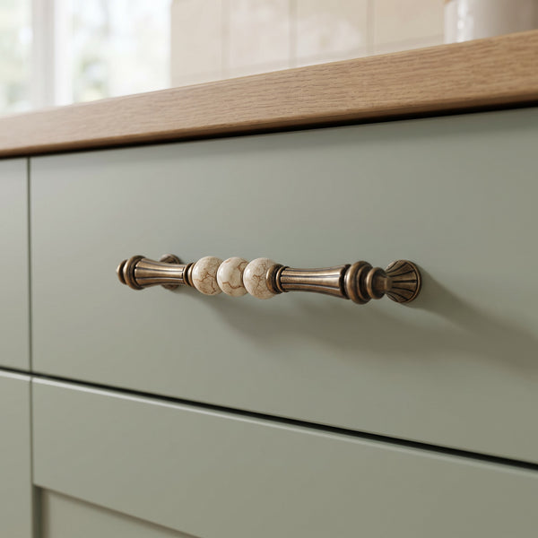 Bellora Curved Dome Bar Handle in Antique Brass+Brown, 160mm, fitted on a kitchen drawer