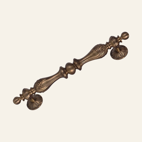 Dragos solid brass pull handle, leaf-cast baluster with centre ball