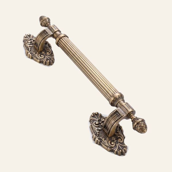 Regalio solid brass pull handle with reeded grip and scrolled shield mount
